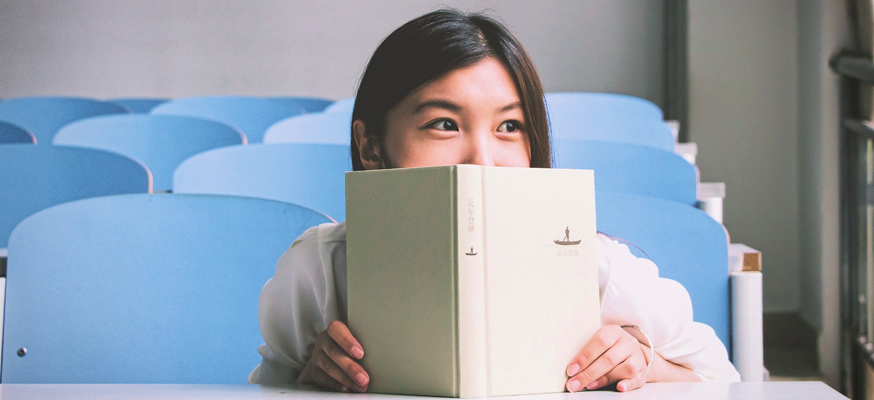 Girl reading in auditorium